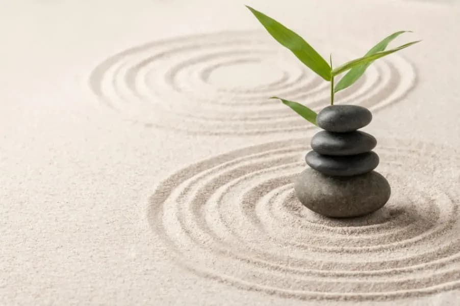 stacked zen stones sand background art of balance concept